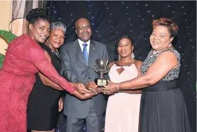  ?? CONTRIBUTE­D ?? The quartet comprising management and staff of First Regional Co-operative Credit Union: Lorraine Brown-Wright (left), Karen Sangster (second left), Jodi-Ann Price (second right) and Patricia Smith flanks JCCUL President Winston Fletcher as they celebrate winning the Mega Credit Union of the Year Award for 2017.