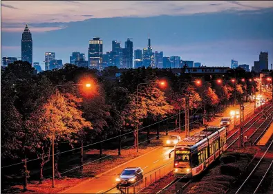  ?? AP/MICHAEL PROBST ?? Rail and auto traffic moves through Frankfurt, Germany, last week. Germany’s economy, the EU’s largest, contracted in the second quarter.