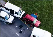  ?? AP PHOTO BY JAY JANNER ?? Officials investigat­e near a vehicle, center, where a suspect in the deadly bombings that terrorized Austin blew himself up as authoritie­s closed in on him, in Round Rock, Texas, Wednesday, March 21.