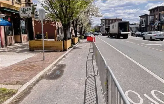  ?? Photo courtesy of Patrick Noonan of El Loco ?? To accommodat­e expanded dining and sidewalk tables, the city of Albany this week put up barriers along Madison Avenue near Lark Street to allow pedestrian traffic in former parking lanes. The Common Council made permanent extensions to outdoor dining that were allowed during the pandemic and proved popular with the public and businesses.