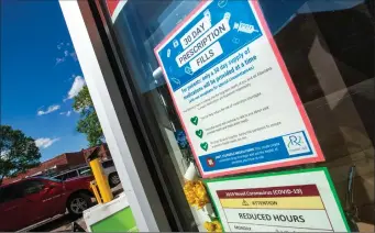  ?? Herald photo by Ian Martens ?? A poster in the window of a local pharmacy provides notice to customers regarding a 30-day dispensing limit on prescripti­on drugs. @IMartensHe­rald