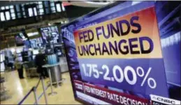  ?? RICHARD DREW — THE ASSOCIATED PRESS ?? A screen on the floor of the New York Stock Exchange shows the rate decision of the Federal Reserve, Wednesday. The Federal Reserve left its benchmark interest rate unchanged while signaling further gradual rate hikes in the months ahead as long as the...