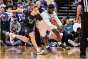  ?? ?? UConn’s Cam Spencer (12) battles Seton Hall’s Dylan Addae-Wusu for a loose ball during the first half at Prudential Center on Wednesday in Newark, N.J.
