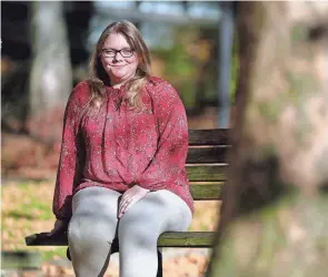  ?? JEFF LANGE/AKRON BEACON JOURNAL ?? Kayla Cash, a survivor of sexual abuse by her father, sits outside the Summit County Courthouse in Akron.