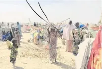  ?? PHOTOS: THOMSON REUTERS FOUNDATION ?? Pitching in . . . A refugee child in Goura carries sticks to help build a shelter.