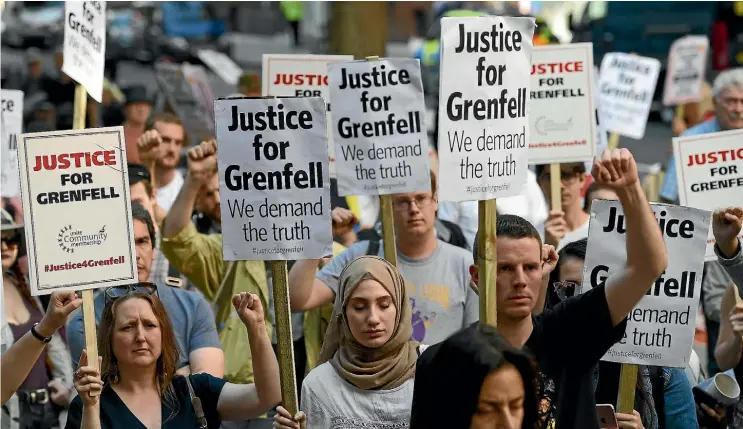  ??  ?? Protesters attend a rally calling for justice for those affected by the Grenfell Tower fire in London yesterday.