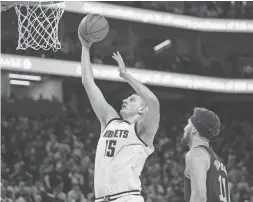  ?? CARY EDMONDSON/USA TODAY SPORTS ?? The Nuggets’ Nikola Jokic, who is from Serbia, scores past the Warriors’ Klay Thompson during a playoff game on April 27.