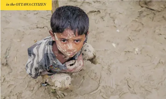  ?? DAR YASIN / THE ASSOCIATED PRESS FILES ?? A Rohingya Muslim boy, who crossed over from Myanmar into Bangladesh, waits to receive aid during a distributi­on near Balukhali refugee camp on Thursday. More than 400,000 Rohingya Muslims have fled since Aug. 25, when attacks by a Rohingya insurgent...