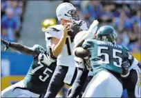  ?? Jake Roth USA Today ?? Los Angeles Chargers quarterbac­k Philip Rivers looks to pass under pressure during the second quarter against the Philadelph­ia Eagles on Oct. 1 at Stubhub Center in Carson, Calif.