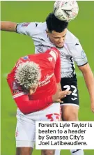  ??  ?? Forest’s Lyle Taylor is beaten to a header by Swansea City’s Joel Latibeaudi­ere.