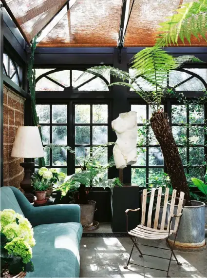  ??  ?? The conservato­ry Zinc planters filled with Tasmanian Dicksonia ferns and classical sculptures fill the space.
Nurseries In a bougainvil­leafilled greenhouse, potted plants adorn tables and vintage mirrors add a decorative touch.
The garden A striking...