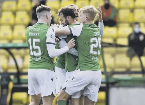 ??  ?? 0 Christian Doidge celebrates with team-mates after equalising for Hibs at Livingston on Saturday