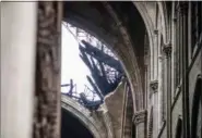  ?? CHRISTOPHE PETIT TESSON — THE ASSOCIATED PRESS ?? A hole is seen in the dome inside the damaged Notre Dame cathedral in Paris on Tuesday.