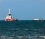  ?? ?? Vessels carrying humanitari­an aid wait offshore near Gaza City.