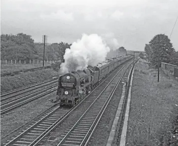  ??  ?? On a very wet August 6, 1962, British India Line speeds through New Malden with the 11.00 WaterlooIl­fracombe ‘Atlantic Coast Express'. DON BENN