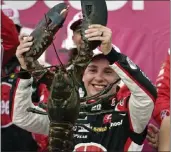  ?? CHARLES KRUPA — THE ASSOCIATED PRESS ?? NASCAR driver Christophe­r Bell holds up a giant lobster after winning a Cup Series race in New Hampshire.