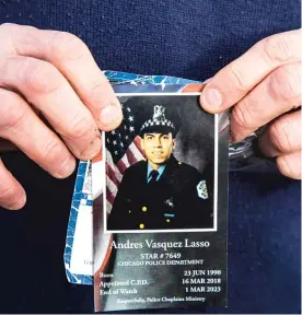  ?? ?? Mourner David Dewar shows the prayer card for fallen Officer Andres Vasquez Lasso.