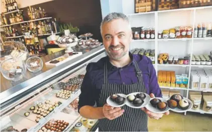  ?? Helen H. Richardson, The Denver Post ?? Phil Simonson shows off some of his unique truffles made by hand at Chocolate Lab.