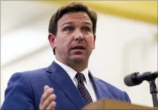  ?? MATIAS J. OCNER — MIAMI HERALD VIA AP, FILE ?? This May 4 2021 file photo shows Florida Gov. Ron DeSantis, center, speaks during a news conference at West Miami Middle School in Miami.