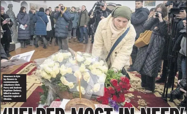  ?? ?? Mourners in Kyiv lay flowers to commemorat­e volunteers Chris Parry and Andrew Bagshaw (below), killed in eastern Donetsk region of Ukraine.