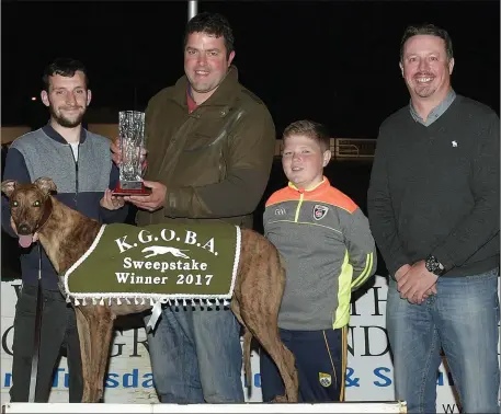  ??  ?? Stephen Reidy accepts the winner’s trophy on behalf of the owner from Jonathon Best (K.G.O.B.A.) after Chespirito won the K.G.O.B.A Stakes final for Confined A5 Greyhounds at the Kingdom Stadium on Friday night. Included are Keelan Best and Kieran...