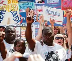  ?? AFP ?? Supporters of the campaign group ‘Black Men for Bernie’ express their backing for Bernie Sanders during the 2016 Democratic National Convention.