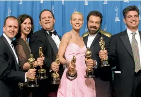  ??  ?? Weinstein, third from left, celebrates with the co-producers and stars of Shakespear­e In Love after that film won seven Oscars at the 1999 Academy Awards - part of a string of successes for Miramax Films during the 1980s and 1990s.
