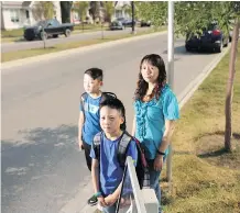  ?? LEAH HENNEL ?? Cindy Lui is upset her boys Ethan Tang, 11, left, and Evan Tang, 9, have to catch their school bus so early in the morning.