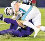  ?? CP PHOTO ?? Miami Dolphins middle linebacker Kiko Alonso, top, collides with Baltimore Ravens quarterbac­k Joe Flacco as Flacco slides on the field after rushing the ball during an NFL football game Thursday in Baltimore.