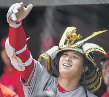  ?? Photograph­s by Jess Rapfogel Associated Press ?? SHOHEI OHTANI celebrates in the dugout after a first-inning home run, his 10th of the season. Ohtani later knocked in the go-ahead run in the eighth on an infield single to salvage a four-game series split for the Angels.