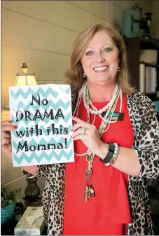  ?? LYNN KUTTER ENTERPRISE-LEADER ?? Angie Gill, counselor at Prairie Grove Middle School, displays the flier and motto she keeps on her door. Gill was named Arkansas Middle School Counselor of the Year this summer.