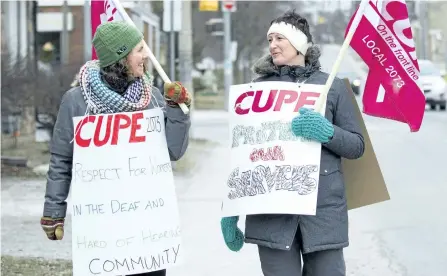  ?? JESSICA NYZNIK/EXAMINER ?? Anna McIntosh, left and Maria Shuwera, unionized employees of the Canadian Hearing Society, picket outside their workplace on Reid Street on Monday. CUPE Local 2073 declared a strike Monday after nearly two months at the bargaining table with their...