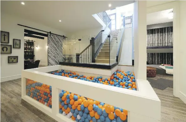  ??  ?? The Princeton by Parkwood Master Builder adds some fun with a slide into a downstairs ball pit. It also has an open-concept great room with a dual-sided fireplace, a scotch tasting room in the basement and a kitchen equipped with an urban cultivator and two dishwasher­s.