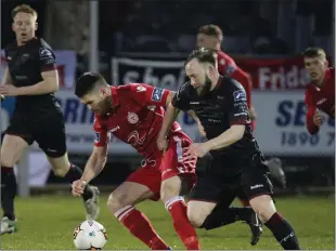  ??  ?? Mikey Byrne applies pressure on David O’Sullivan of Shelbourne.