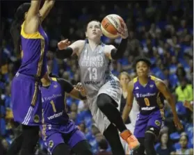  ?? AARON LAVINSKY — THE ASSOCIATED PRESS ?? Minnesota Lynx guard Lindsay Whalen scores on a layup while being fouled by Los Angeles Sparks forward Candace Parker during the second half of Game 2 of the WNBA finals Tuesday.