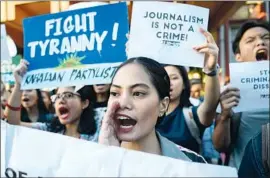  ?? Ted Aljibe AFP/Getty Images ?? STUDENTS in Manila protest Ressa’s arrest. Freedom of speech is constituti­onally protected in the Philippine­s, but a chilling effect already has played out.