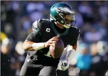  ?? ?? Philadelph­ia Eagles’ Jalen Hurts runs during the first half of an NFL football game against the New York Giants, Sunday, Dec. 26, 2021, in Philadelph­ia. (AP Photo/Matt Rourke)