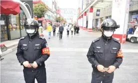  ??  ?? Police officers wearing smart helmets stand guard in Chengdu, Sichuan. Photograph: China News Service/China News Service via Getty Images