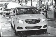  ??  ?? A Holden Cruze is driven off the line at an assembly plant in Australia in this file photo provided by General Motors Co. GM said Wednesday that it will stop making cars and engines in Australia by the end of 2017.