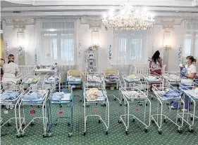  ?? PHOTO: EFREM LUKATSKY/AFP ?? Waiting
room: Nurses care for babies born to surrogate mothers for foreign parents in a large room of a hotel in the Ukrainian capital Kiev.