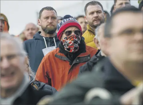  ?? PICTURE: TONY JOHNSON ?? PROTECTION: A fan at the Castleford Tigers v St Helens rugby league game takes precaution­s after an increase in the number of deaths caused by coronaviru­s.