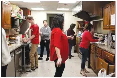  ?? (Courtesy photo) ?? Volunteers prepare a meal for residents in 2019 at the Northwest Arkansas Women’s Shelter in Rogers.