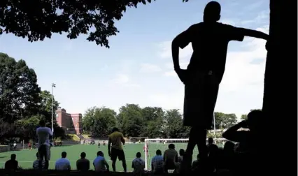  ?? YOON S. BYUN/GLOBE STAFF ?? Spectators gather at Ceylon Park to watch amateur, but highly skilled, Cape Verdean teams play soccer each weekend.