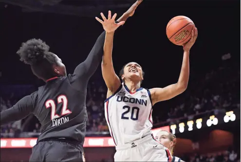  ?? Jessica Hill / Associated Press ?? UConn’s Olivia Nelson-Ododa (20) is fouled by Louisville’s Liz Dixon (22) in the first half on Sunday in Uncasville.