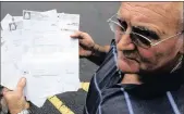  ??  ?? Charles Botha shows all of his electricit­y bills with the latest one standing at R31 941.50. Charles blames the municipali­ty’s meter reading for the outstandin­g amount of his bill.