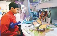  ?? Atiq ur Rehman/Gulf News ?? Students looking at pop-up books at the 3D Book Exhibition being held alongside the reading festival at Expo Centre.