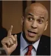  ?? J. SCOTT APPLEWHITE (KAVANAUGH), ALEX BRANDON (BOOKER)/AP ?? Sen. Cory Booker, right, said he was willing to risk fallout over releasing confidenti­al documents about Brett Kavanaugh’s views on race.