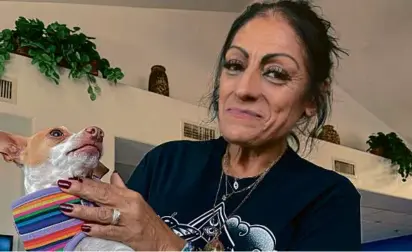  ?? ANITA SNOW/ASSOCIATED PRESS ?? Angelita Saldaña, 56, and her dog, Gaspar, live at a shelter for people 55 and older. Saldaña says her monthly disability check isn’t enough to pay for an apartment in Phoenix.