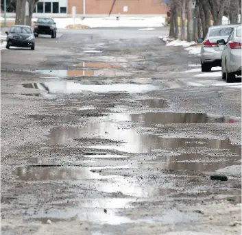  ?? TROY FLEECE ?? Cowan Crescent is just one of the many heavily damaged roads in Hillsdale. Only a quarter of the budget for Regina’s residentia­l roads replacemen­t program goes to roads in poor shape like Cowan Crescent.