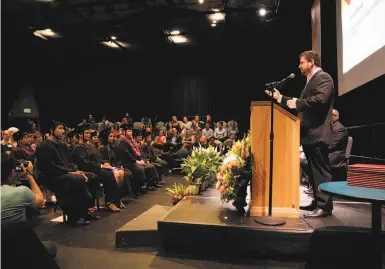  ?? Photos by Carlos Avila Gonzalez / The Chronicle ?? Adrian Ridner, CEO of Study.com and founder of Working Scholars, speaks at the graduation ceremony.